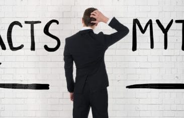 man looking at arrows and writing on wall reading facts and myths