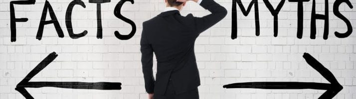 man looking at arrows and writing on wall reading facts and myths