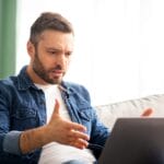 angy man on laptop